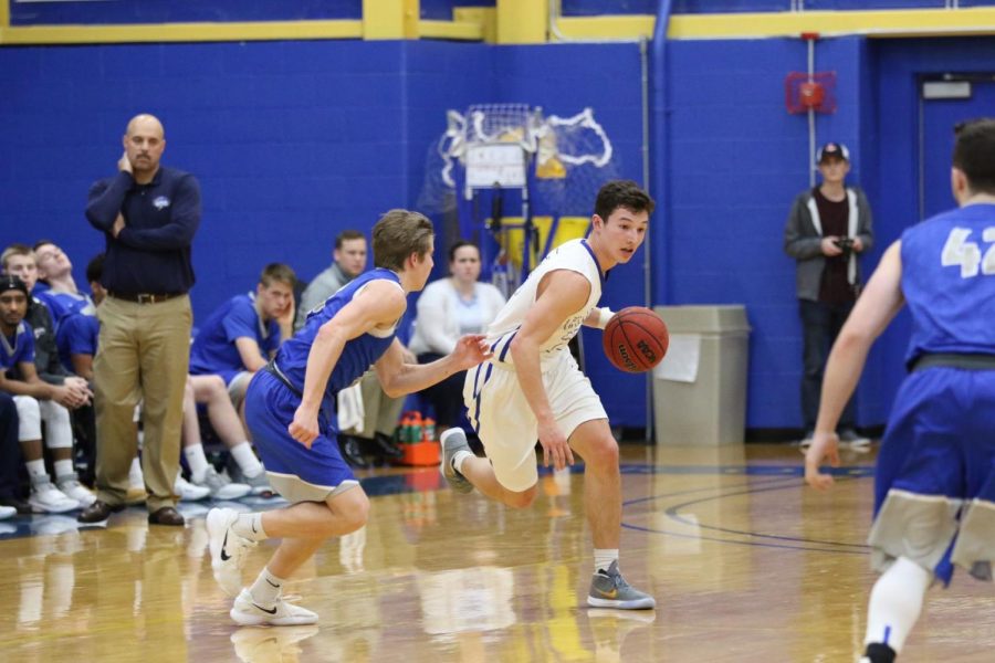 Roger Williams University mens basketball junior guard Austin Coene dribbles the ball up-court against University of New England on Saturday, Jan. 27. The Hawks topped the Noreasters 90-83. 
