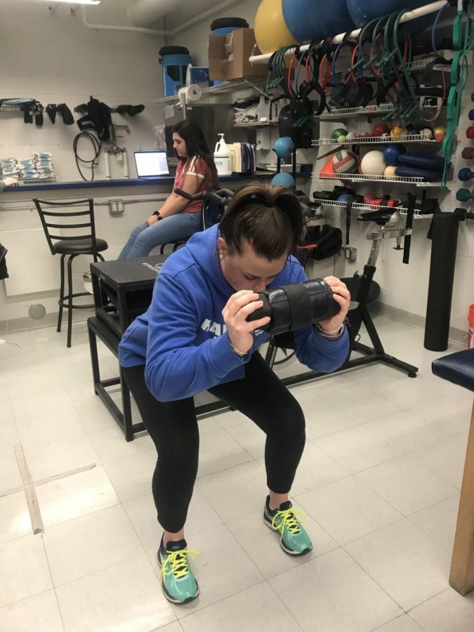 Junior Abby Wollenberg works out in a RWU training room.