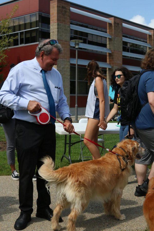 President Miaoulis loves to bring his dog Fletcher to campus. They are pictured here at  the 2019 Involvement Fair