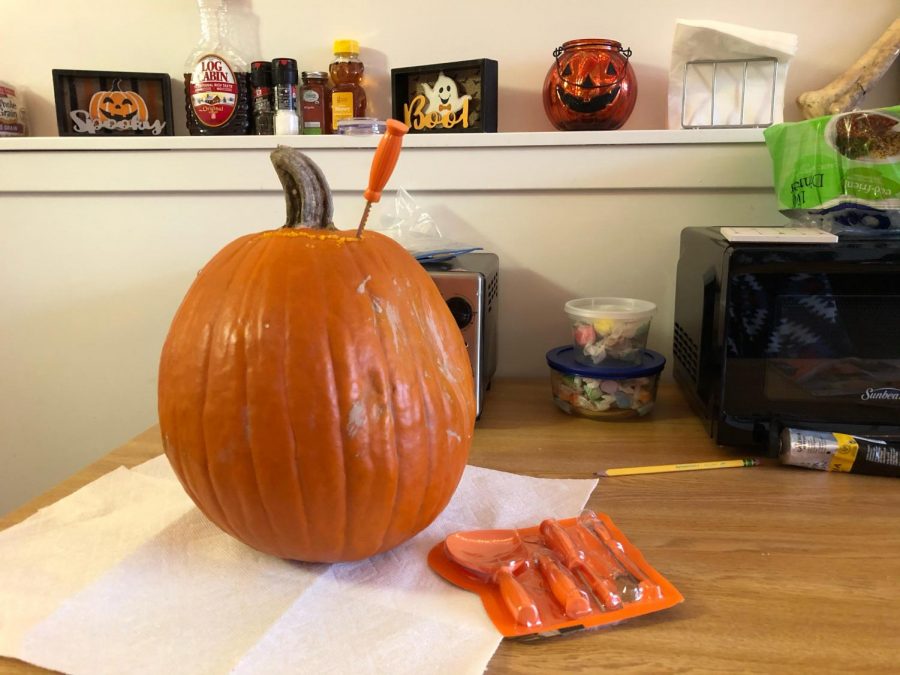 A+work-in-progress+pumpkin+with+the+carving+kit+handy+nearby.+