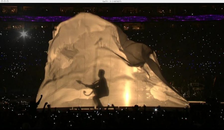  giant sheet shoots up and reveals a thirty-foot shadow of Prince during the 2007 Super Bowl halftime show.