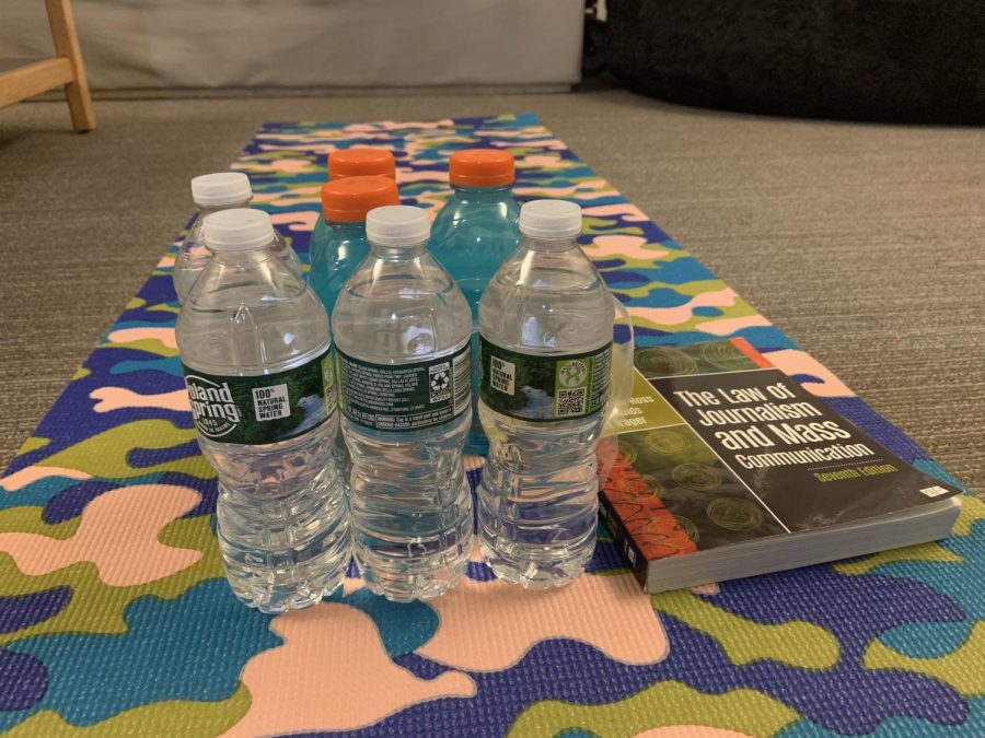 Get creative using alternative weights like water bottles and textbooks for workouts in your residence hall room.