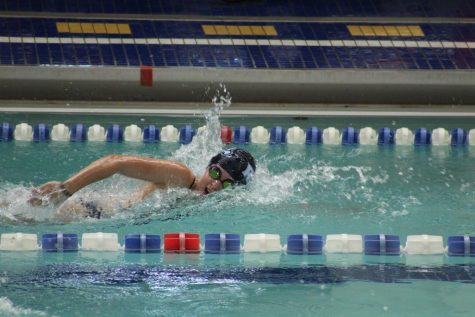 Emily is pictured competing in the sprint event at a swim meet.