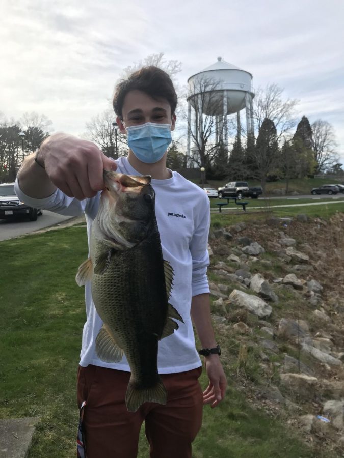 Tyler+Pratt+shows+off+the+bass+he+caught+for+Fishing+Clubs+fishing+derby.+