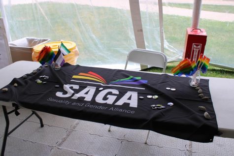 Decorated tables lined the Commons Tent with queer and trans information and resources.