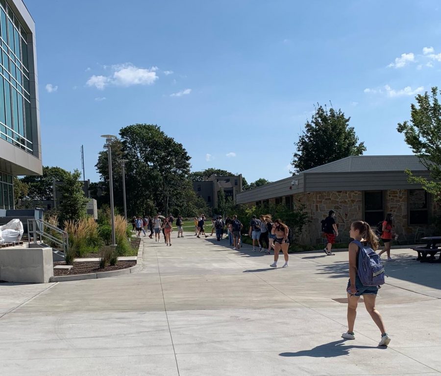 Students walking in between CAS and new SECCM building. Fall semester COVID guidelines say that masks are not required when walking outside.