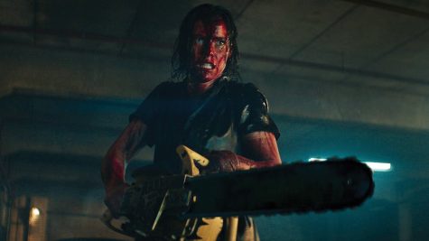Beth (Lily Sullivan) brandishes a chainsaw against the deadites that threaten her estranged family in
Evil Dead Rise.
