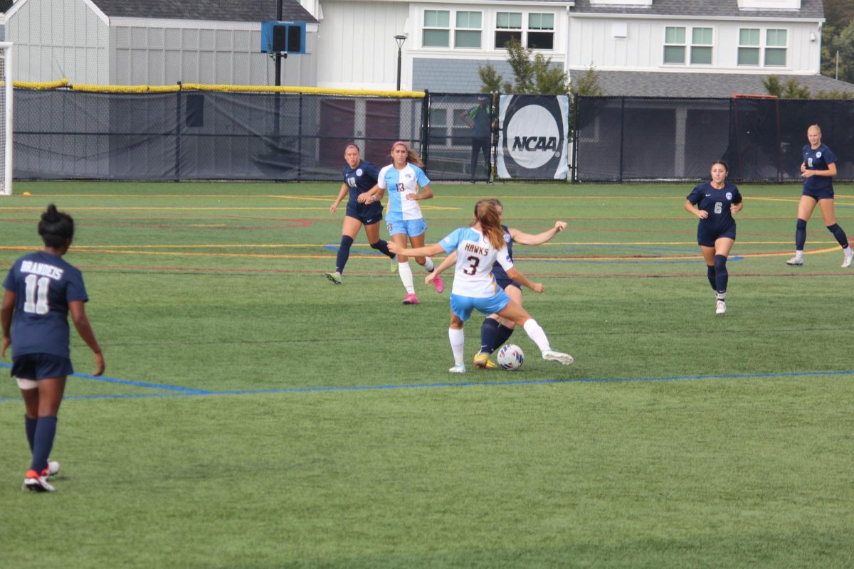 Midfielder%2C+Sophomore+Sarah+Newman%2C+challenges+a+Brandeis+University+player+for+the+ball.+RWU+Women%E2%80%99s+Soccer+team%E2%80%99s+current+record+is+1-4-2.