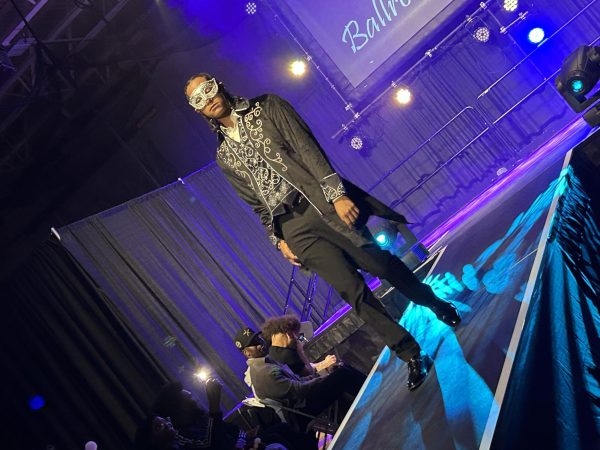 Student walks the runway in a black and white outfit for Barbershop’s
fashion show. 
