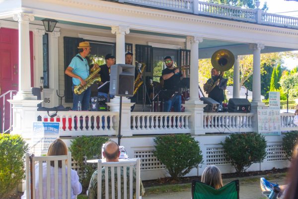 Musicians playing on a porch at Porch Fest 2024. 