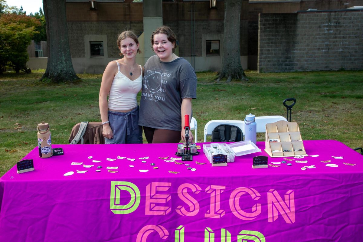 Design Club table at the involvement fair featuring two of their members.