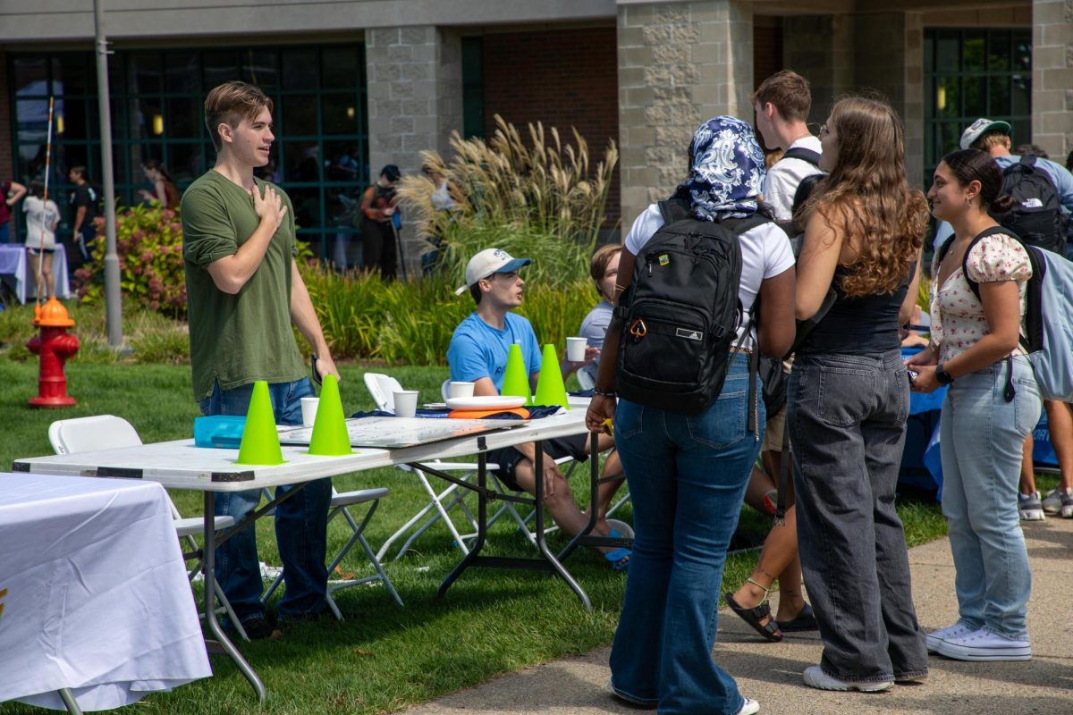 Ultimate Frisbee table at the involvement fair talking to prospective members.