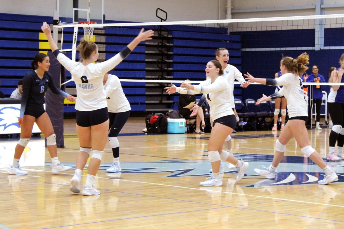 Players celebrate after scoring a point against Wellesley