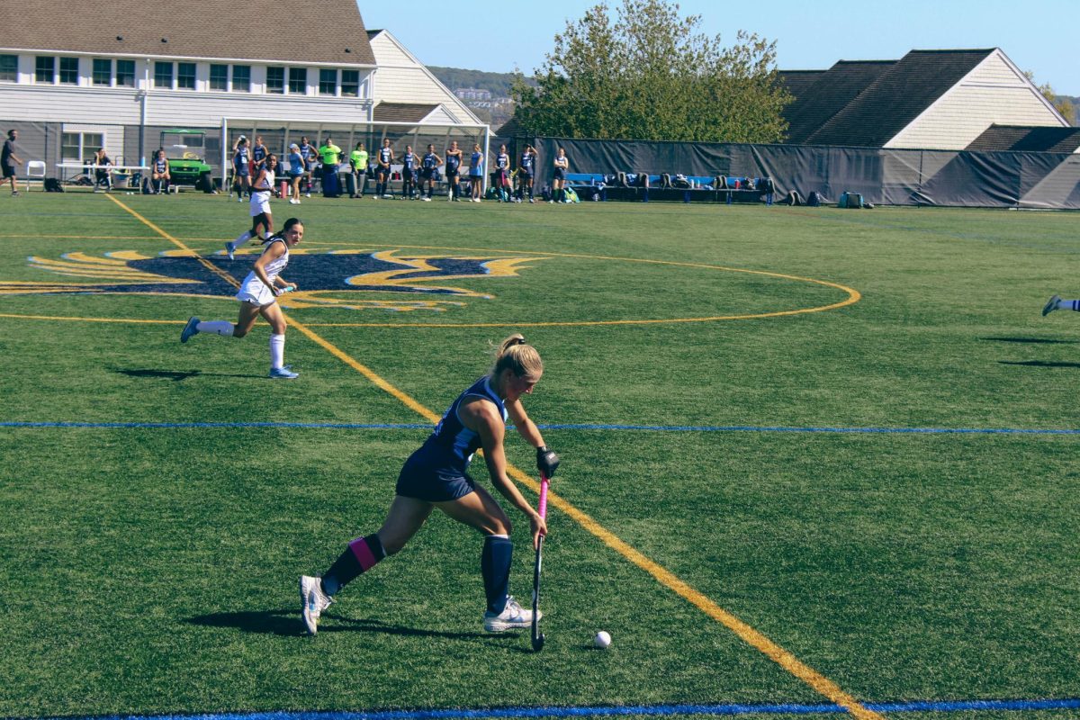 Senior Midfielder Grace Rocheleau carries the ball across midfield