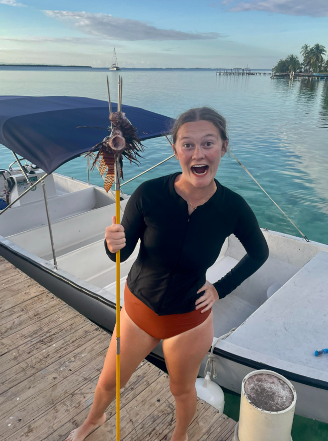 Sydney Zobel, with a lionfish she speared while studying abroad in Belize.